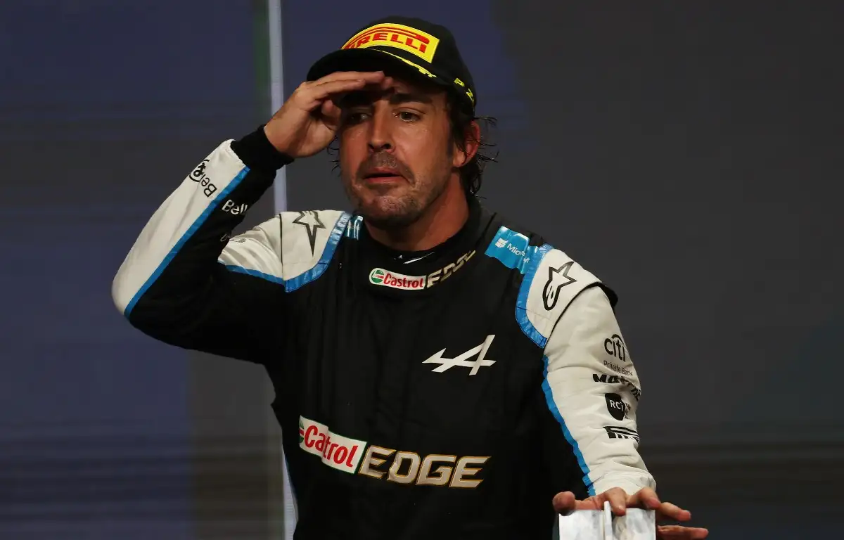 Fernando Alonso looks out from the podium. Qatar, November 2021.