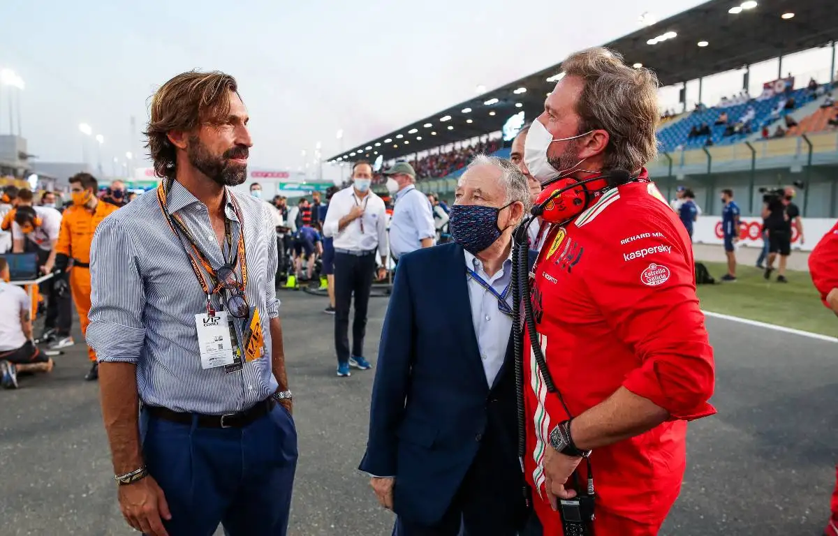 Jean Todt stands with a Ferrari staff member and Andrea Pirlo. Qatar, November 2021.