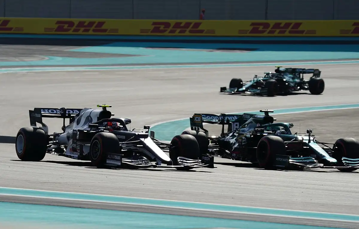 Sebastian Vettel approaches Lance Stroll and Pierre Gasly. Abu Dhabi, December 2021.