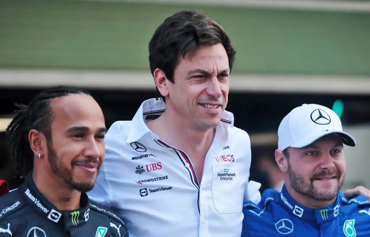 Toto Wolff with his arms around Lewis Hamilton and Valtteri Bottas. Yas Marina December 2021.