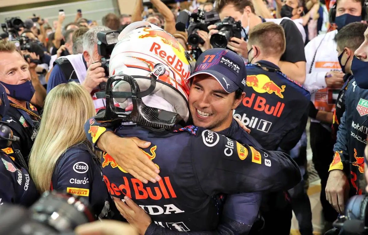 Max Verstappen hugs Sergio Perez after winning the Abu Dhabi GP.