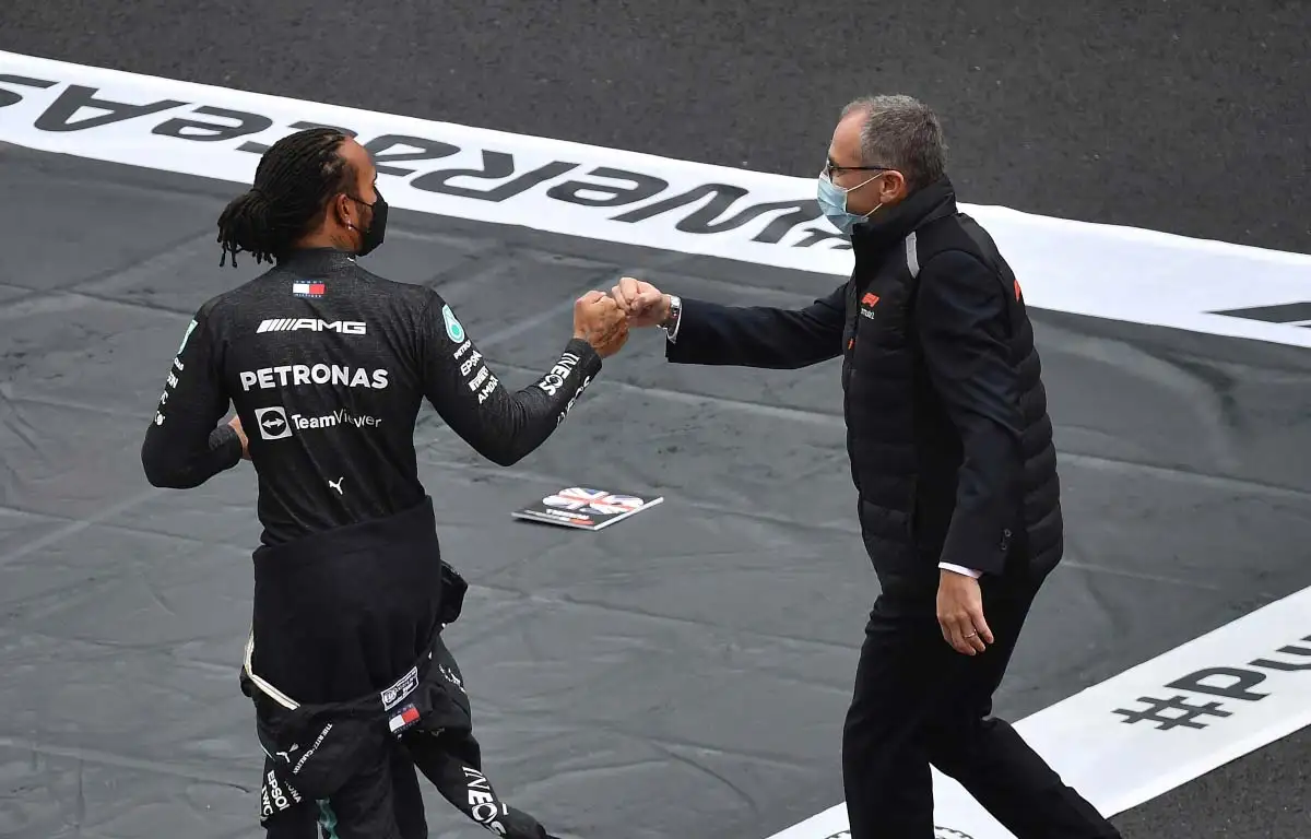 Lewis Hamilton bumps fists with Stefano Domenicali. Turkey October 2021.
