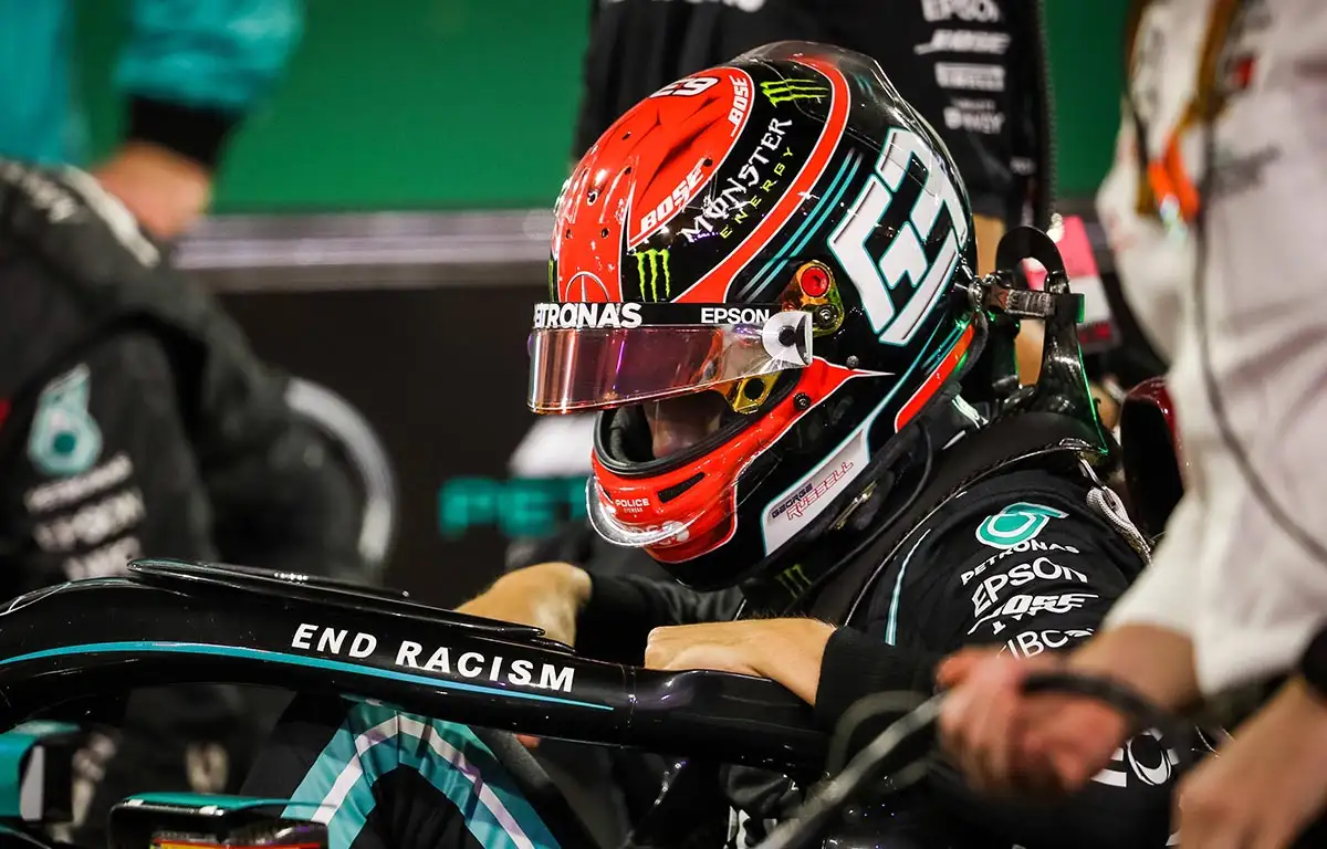 George Russell hops into his Mercedes car. Sakhir Grand Prix 2020