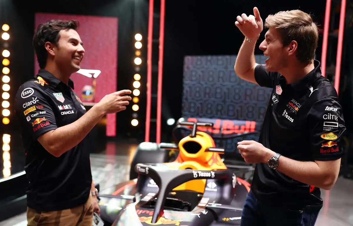 Sergio Perez and Max Verstappen share a joke. Red Bull RB18 launch February 2022.