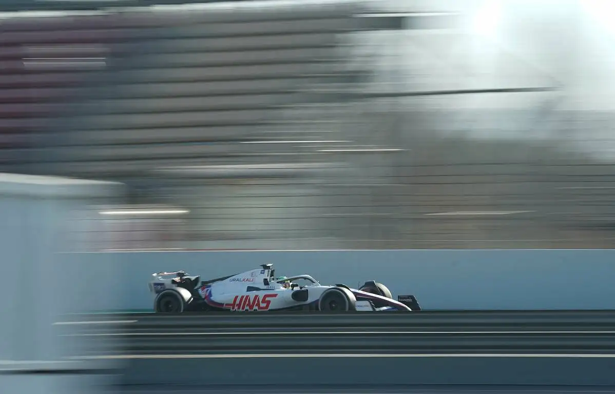 Mick Schumacher drives past a grandstand at the Circuit de Catalunya. Barcelona February 2022.