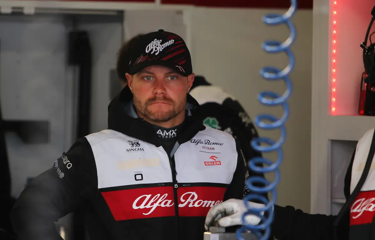 Valtteri Bottas standing in the Alfa Romeo garage looking serious in testing. Barcelona February 2022