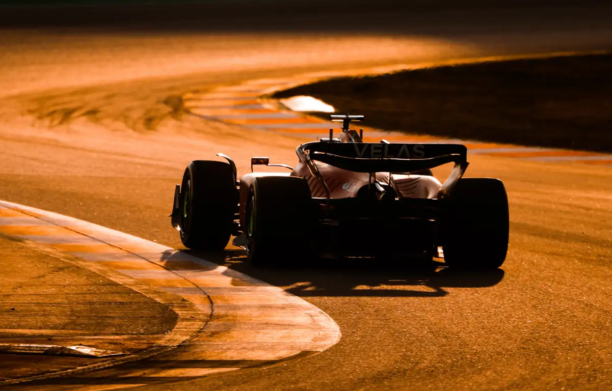 Carlos Sainz in the Ferrari as the sun sets. Barcelona February 2022