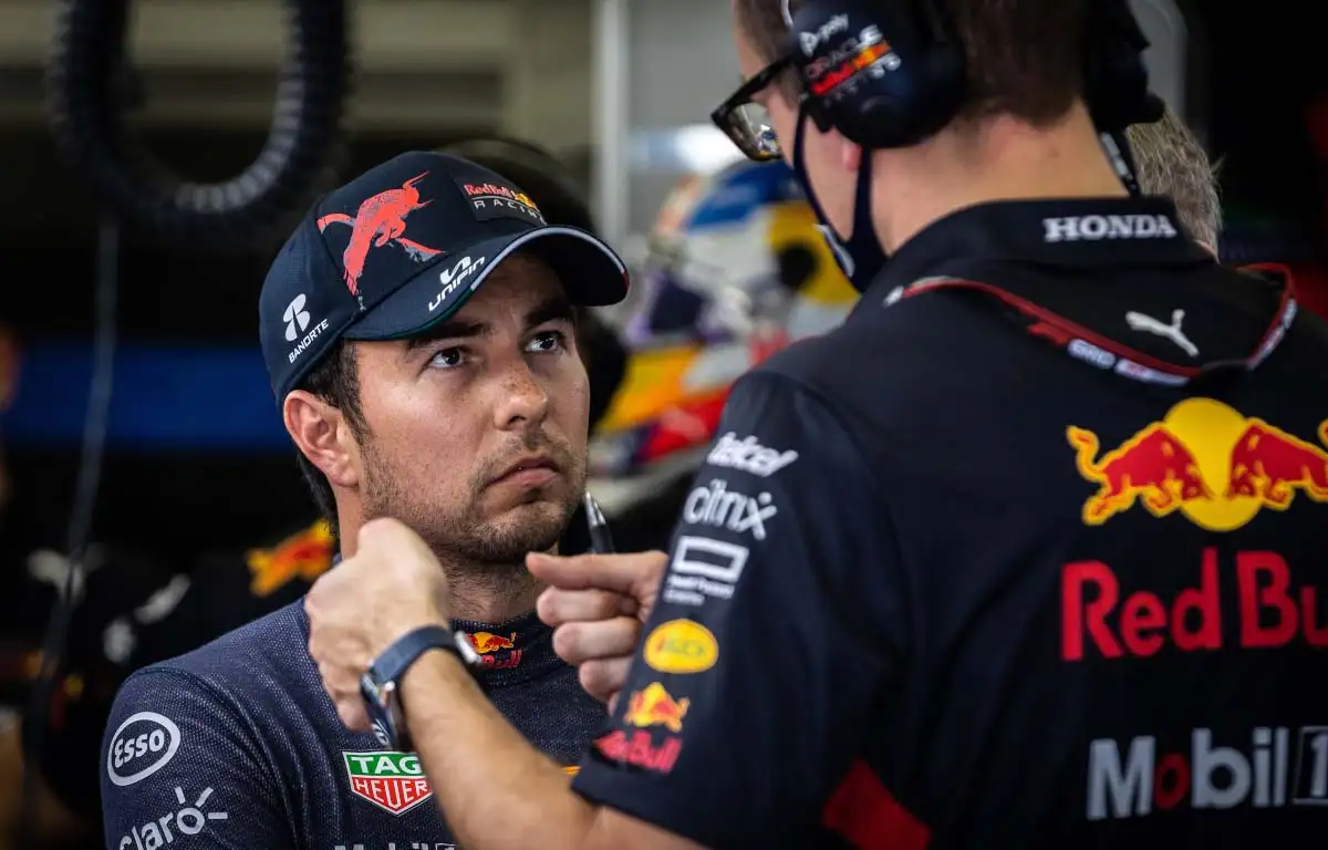 Sergio Perez speaks to a Red Bull engineer. Bahrain March 2022.