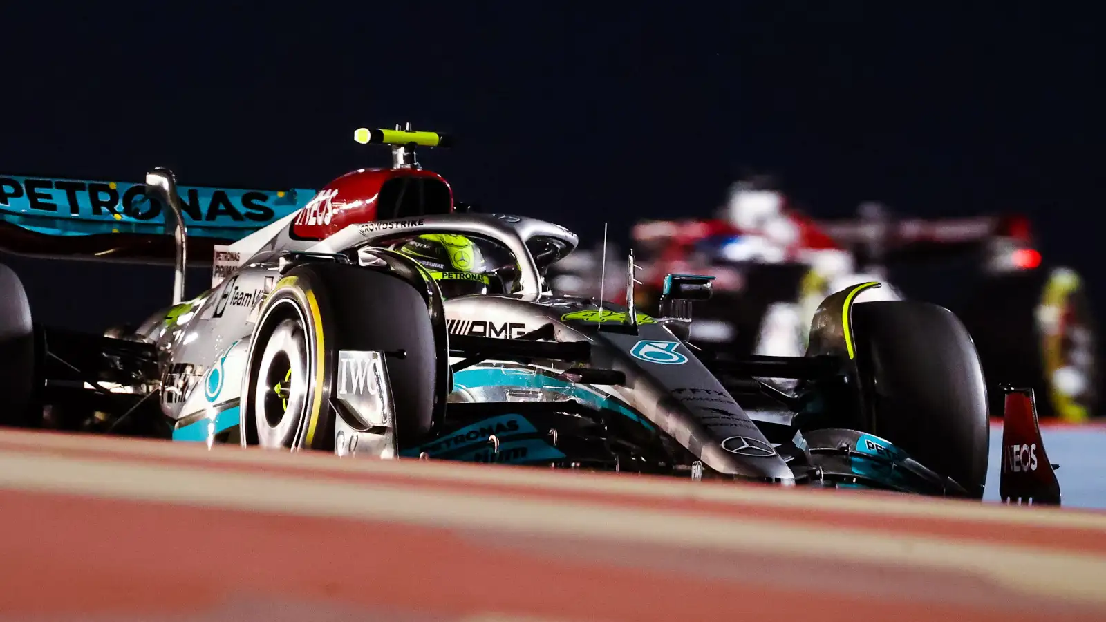 Lewis Hamilton under the lights on the track. Formula 1 Bahrain Grand Prix March 2022