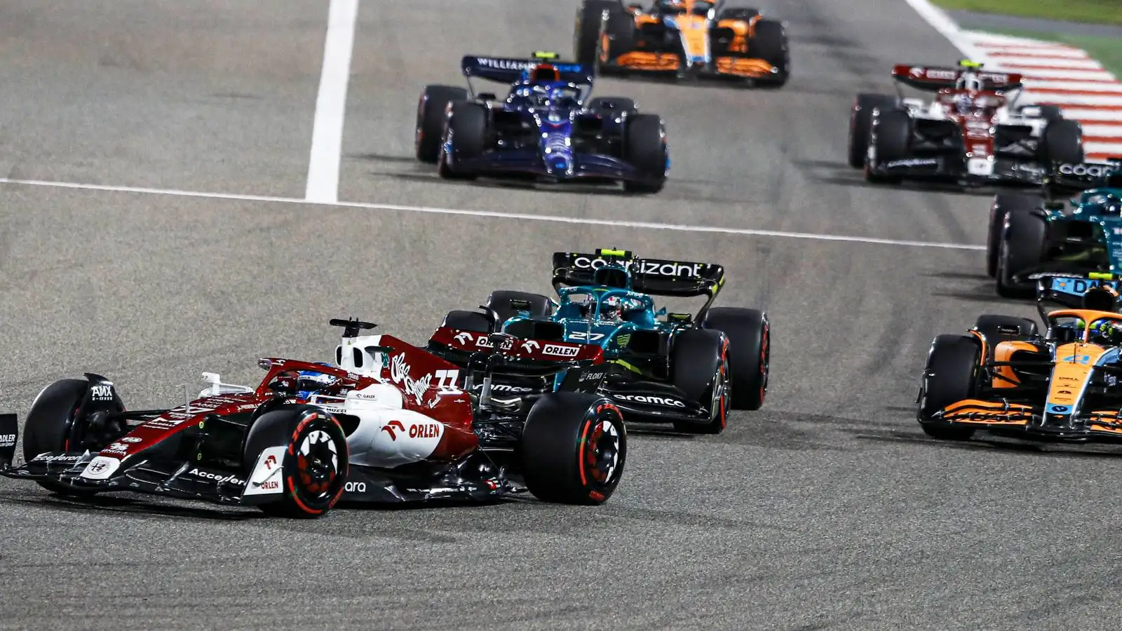 A group of cars follow Alfa Romeo's Valtteri Bottas. Bahrain March 2022.