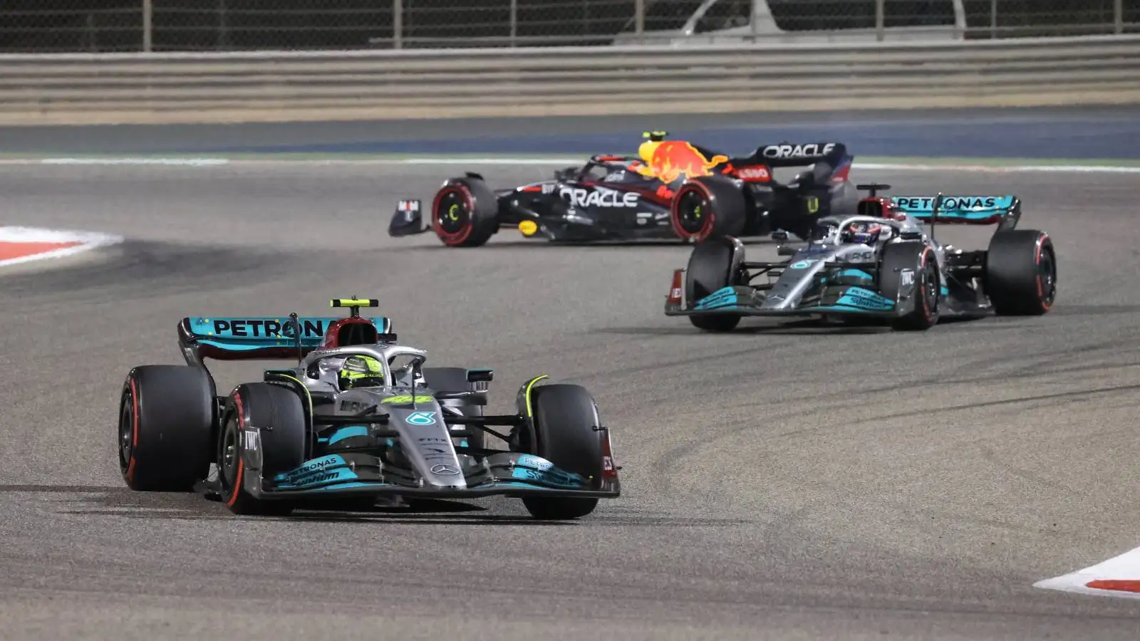 Both Mercedes drive past a stranded Red Bull. Bahrain, March 2022.