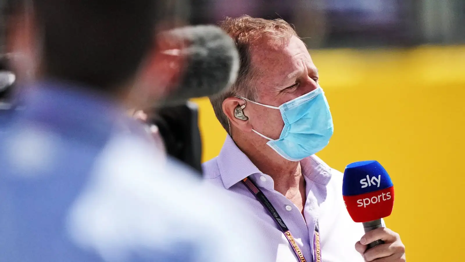 马丁Brundlespeaks into a Sky Sports microphone at the British GP. August 2020.