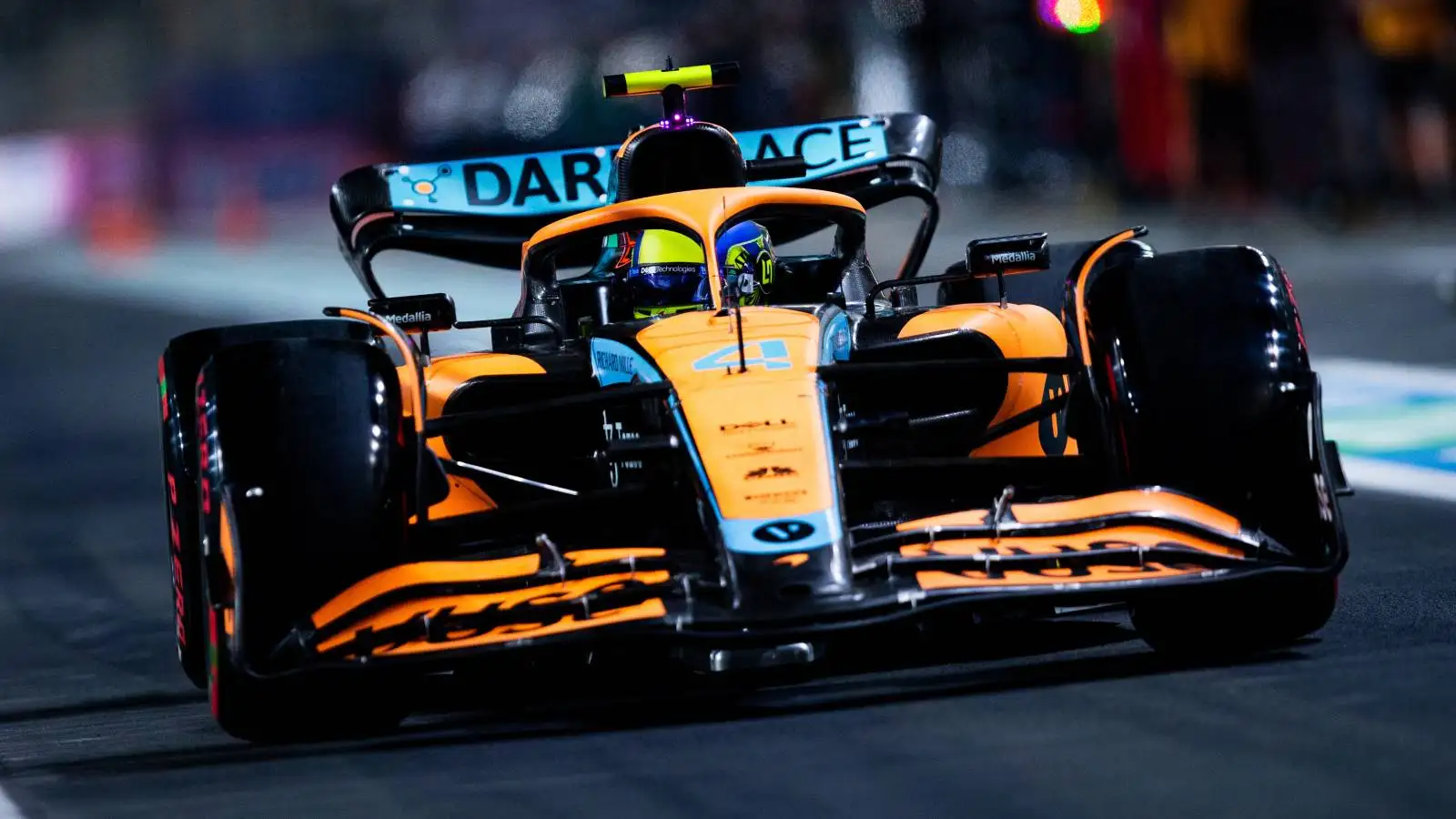 Lando Norris, McLaren, drives in the pit lane. Saudi Arabia, March 2022.