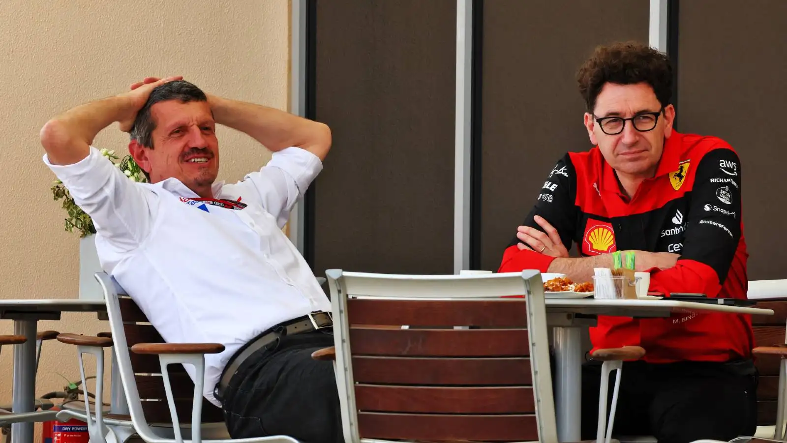 Guenther Steiner sitting with Mattia Binotto. Bahrain March 2022.