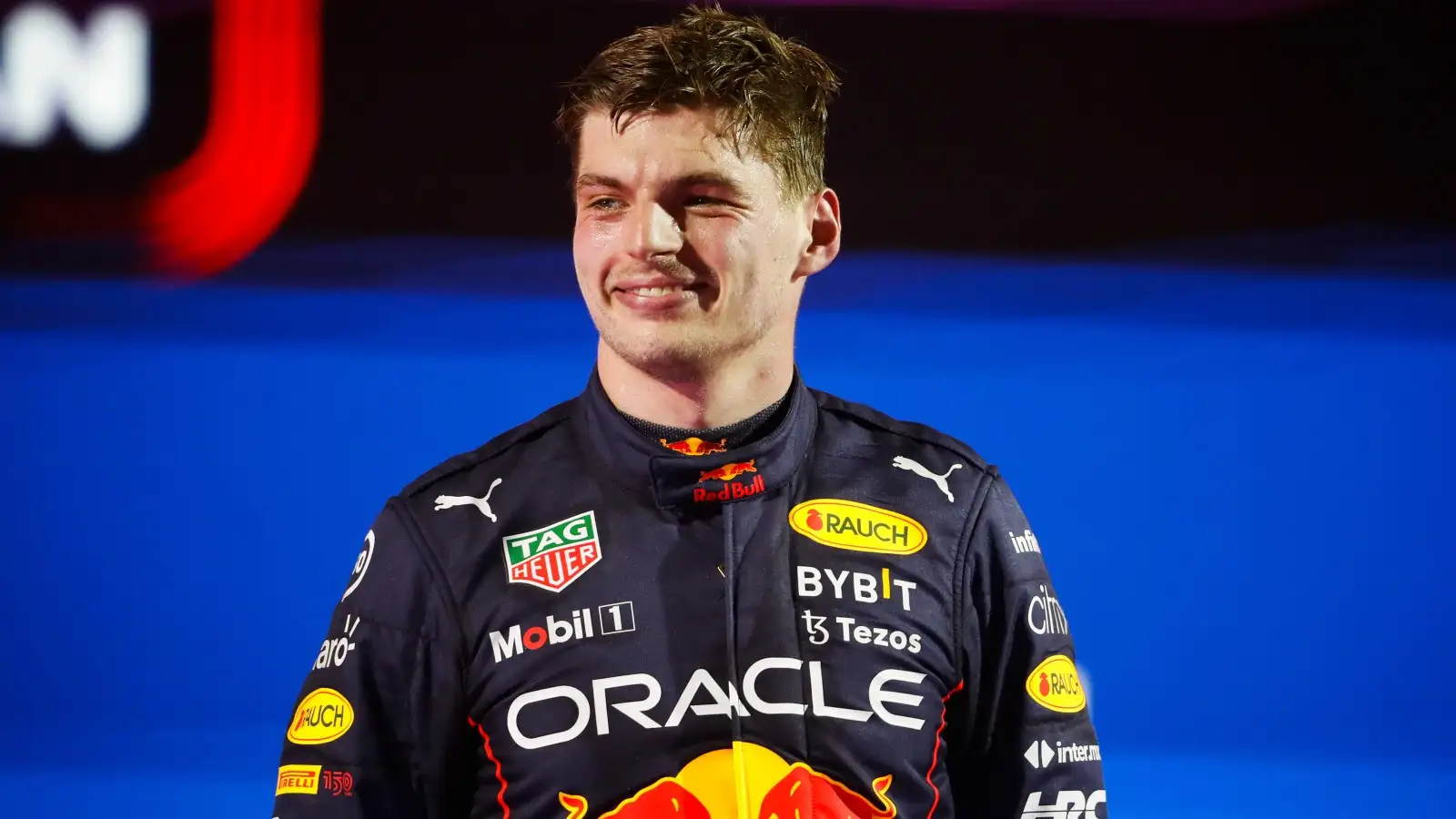 Race winner Max Verstappen, Red Bull, smiling on the podium. Saudi Arabia March 2022.