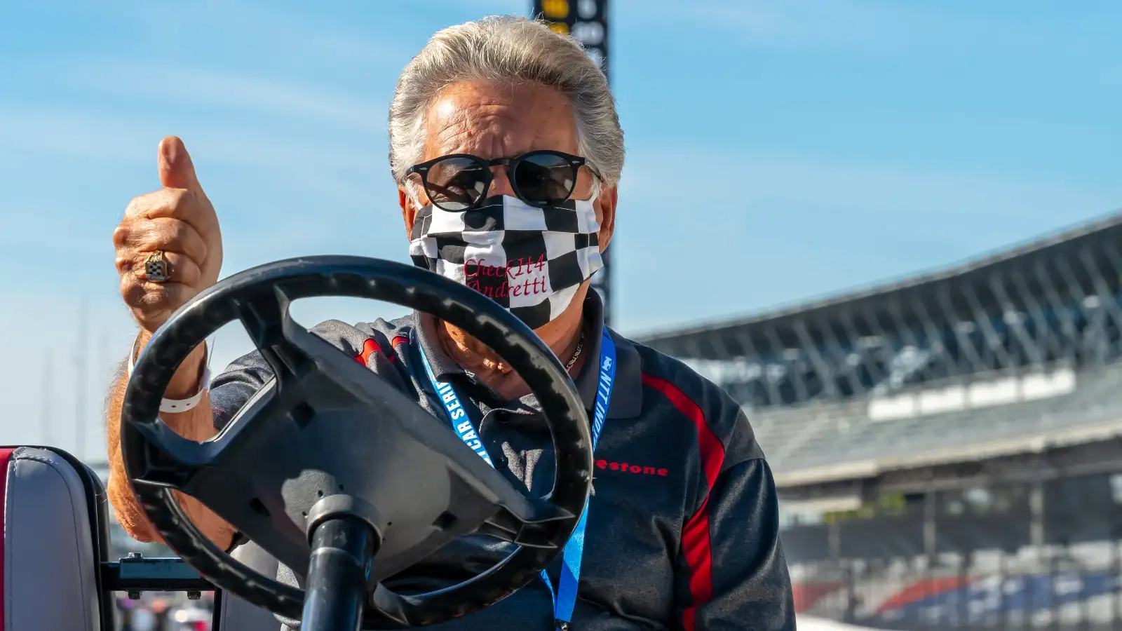 Mario Andretti drives a golf cart. United States, August 2020.