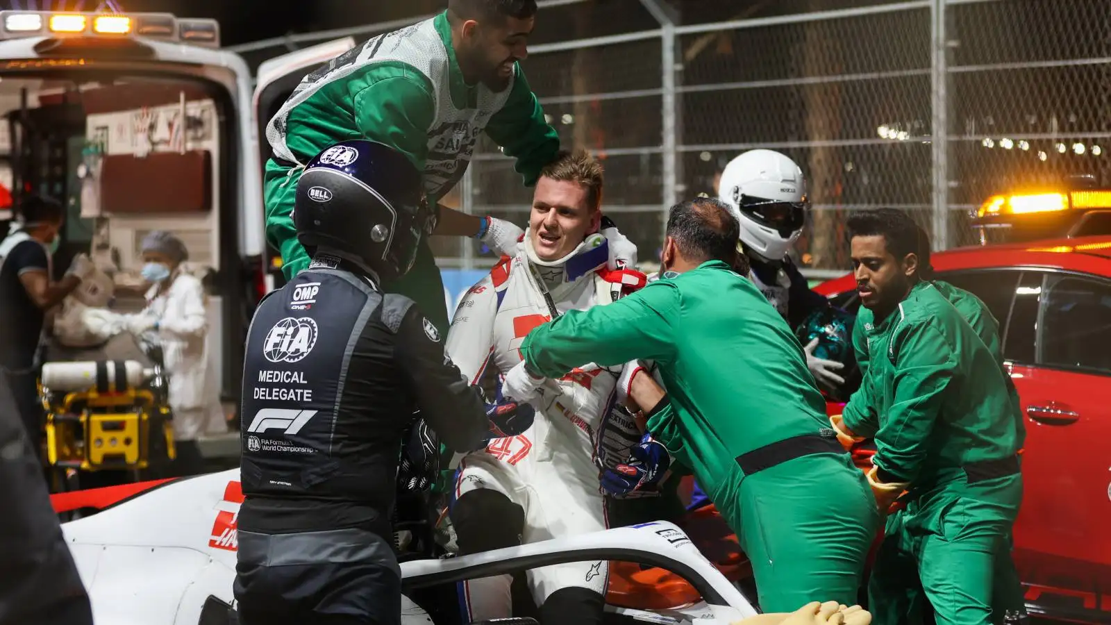 Mick Schumacher helped to get out of his Haas car. Saudi Arabia, March 2022.