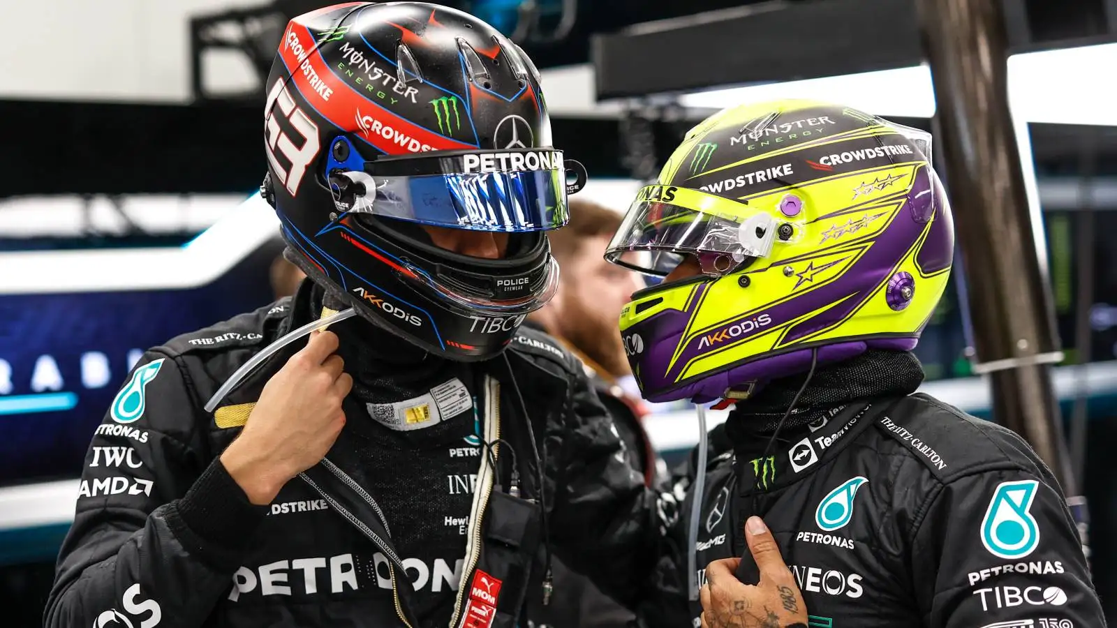 George Russell and Lewis Hamilton talk in the Mercedes garage. Saudi Arabia, March 2022.