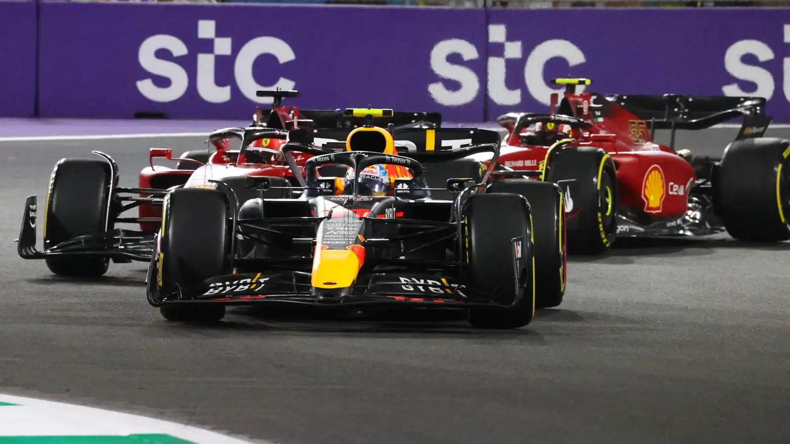 Charles Leclerc and Carlos Sainz, Ferrari, chase Sergio Perez, Red Bull. Saudi Arabia, March 2022.