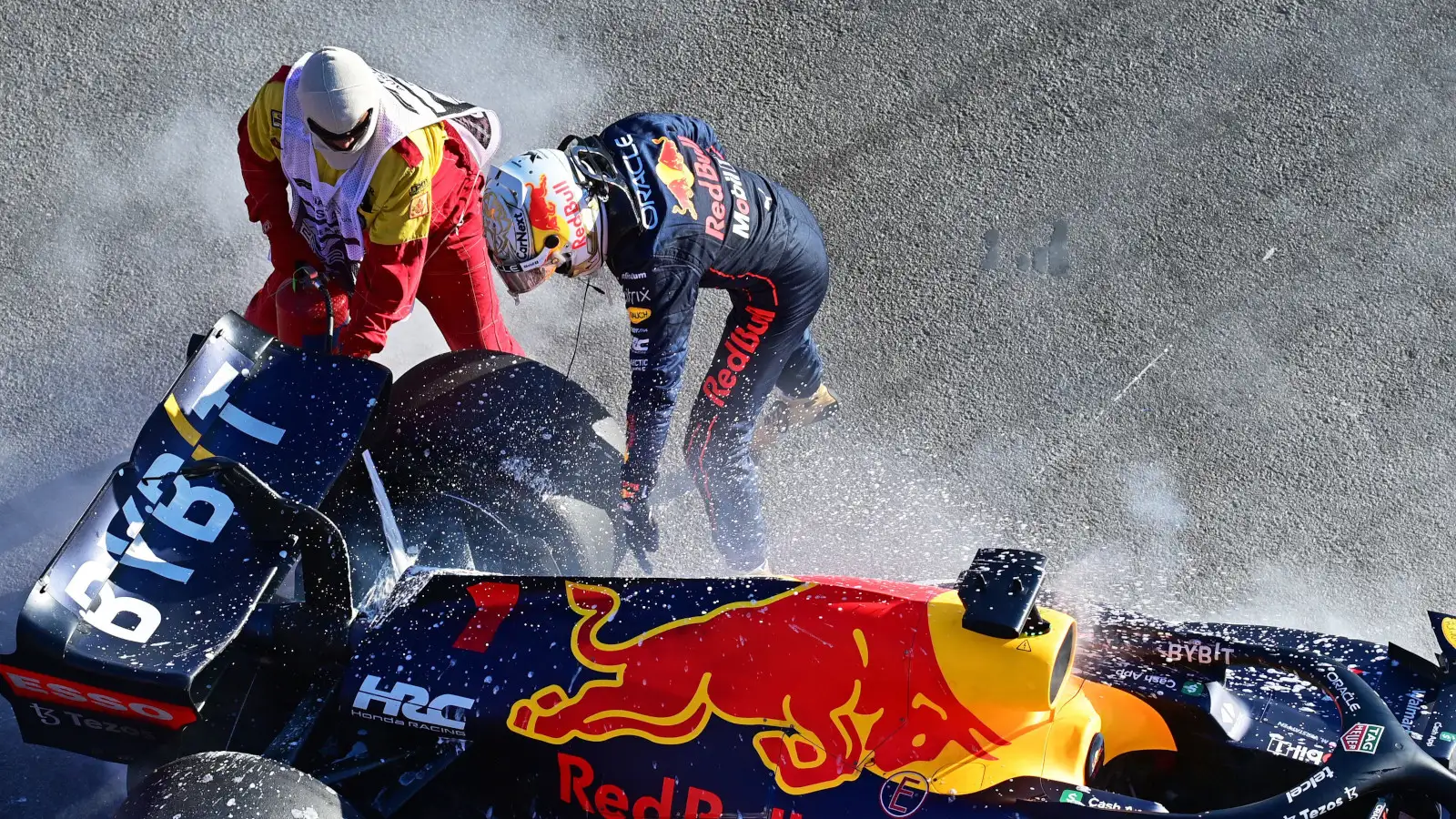 Red Bull driver Max Verstappen points where he wants a marshal to spray fire retardant. Australia April 2022