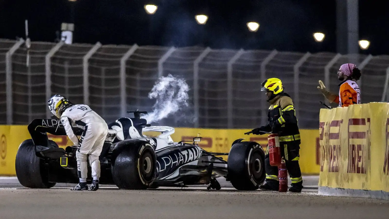 Pierre Gasly stands by his smoking AlphaTauri. Sakhir March 2022.