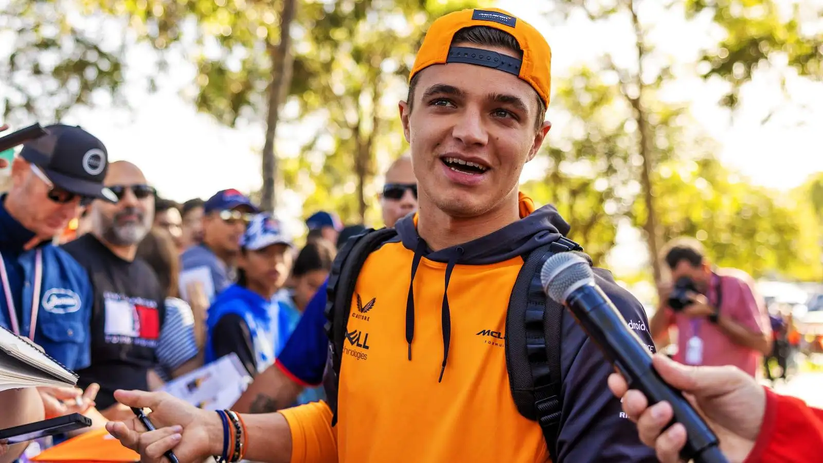 Lando Norris, McLaren, talks into microphone. Australia, April 2022.