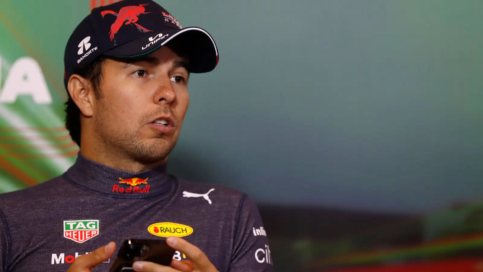 Sergio Perez holding his phone during a press conference. Imola April 2022