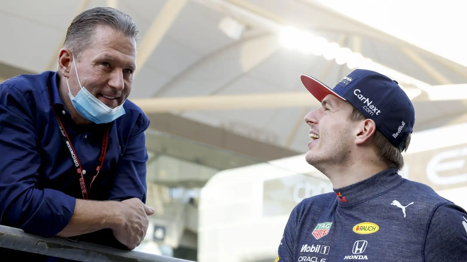 Max Verstappen smiling at his dad Jos Verstappen. Yas Island, December 2021.