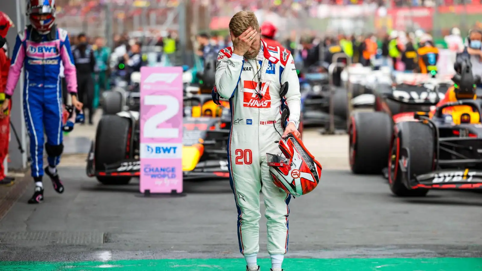 Kevin Magnussen walks with his hand over his face. Imola April 2022.