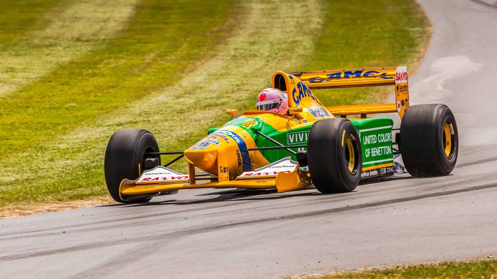 A Benetton F1 car is driven. Goodwood July 2014.