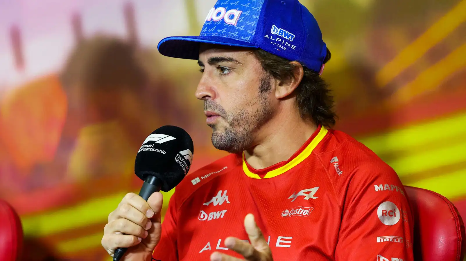 Fernando Alonso holding the microphone in a press conference. Spain May 2022