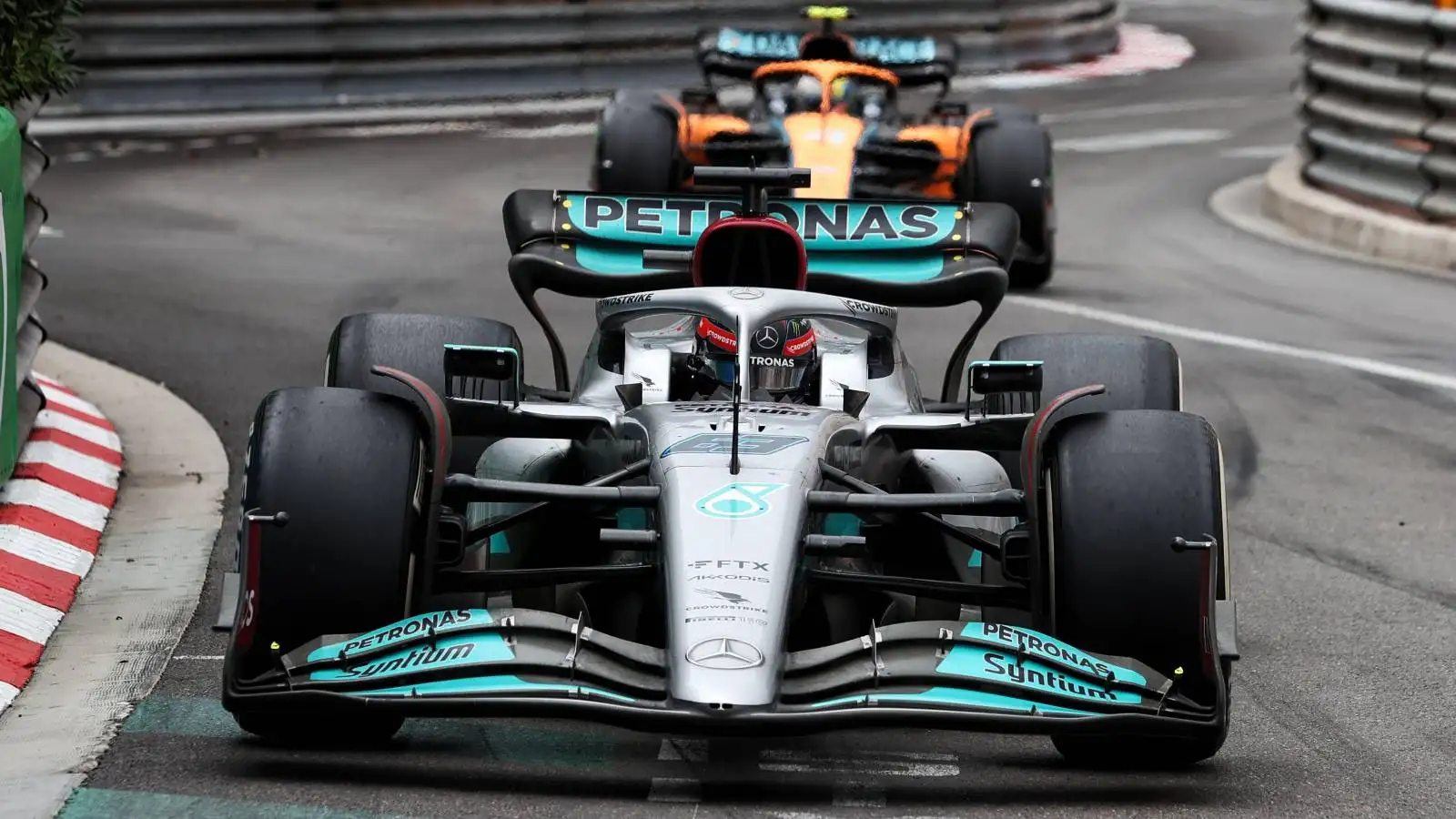George Russell, Mercedes, ahead of Lando Norris, McLaren. Monaco, May 2022.