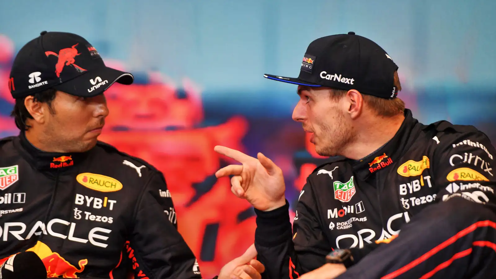Max Verstappen pointing something out to Sergio Perez in the press conference. Monaco May 2022