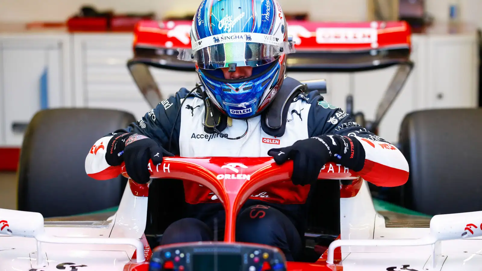 Valtteri Bottas climbs into his Alfa Romeo in the garage. Baku June 2022