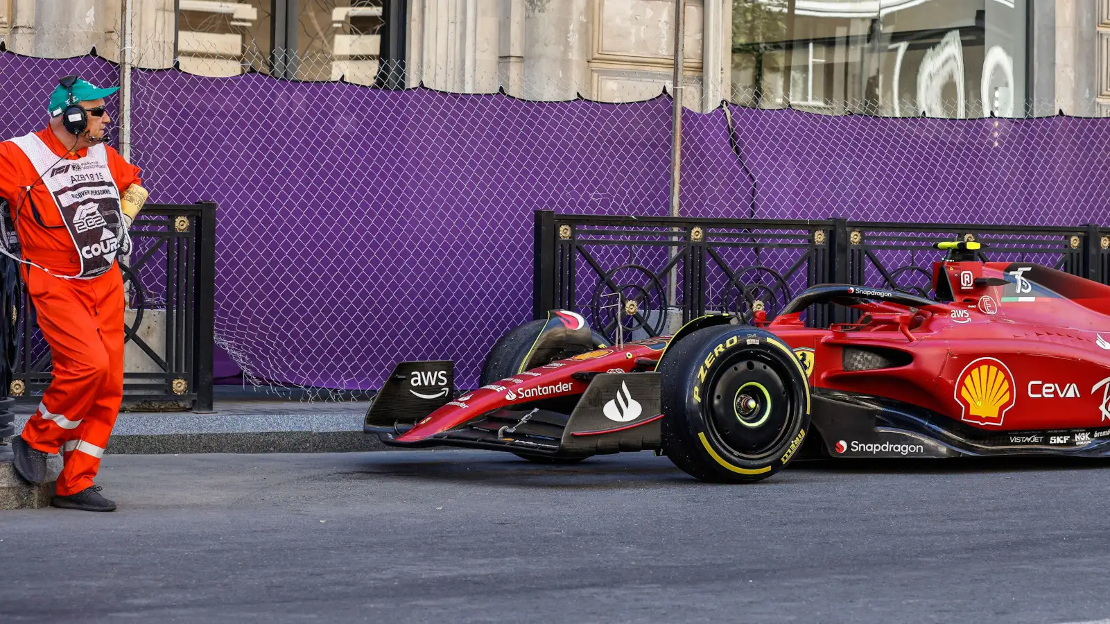Marshal looking at Carlos Sainz's broken down F1-75. Baku June 2022