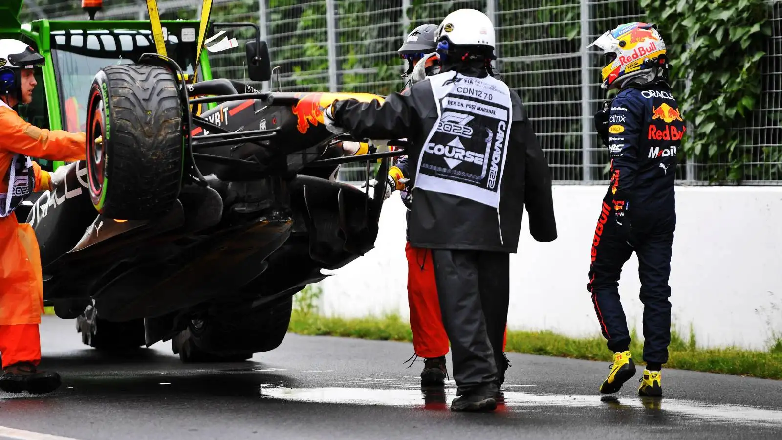 Sergio Perez looks as his crashed Red Bull is removed. Canada, June 2022.