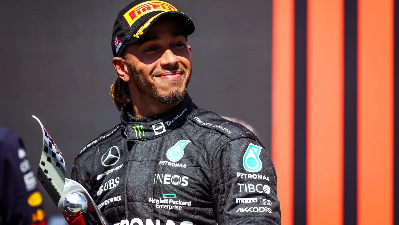 Lewis Hamilton smiling on the podium after finishing third. Montreal June 2022