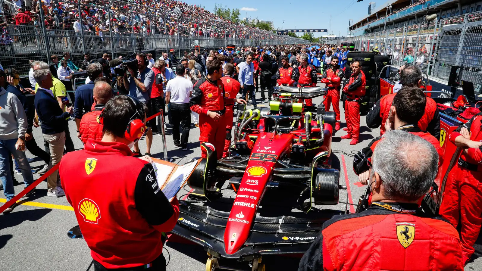 Carlos Sainz's Ferrari on the grid surrounded by mechanics waiting for the start of the race. Montreal June 2022