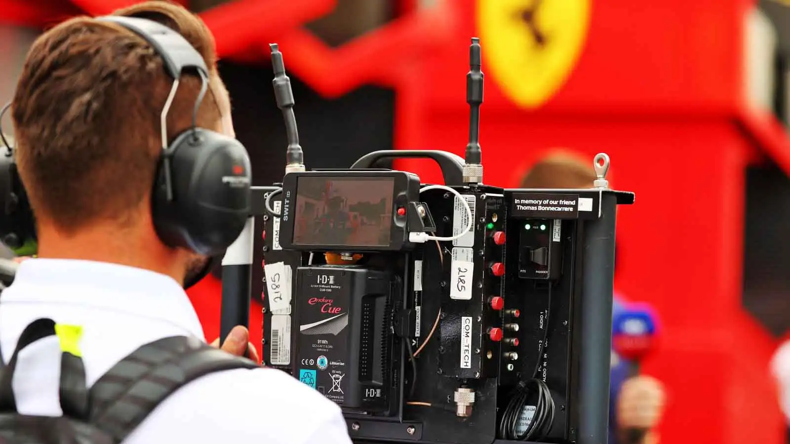 A cameraperson films outside Ferrari. F1 Paul Ricard June 2021.