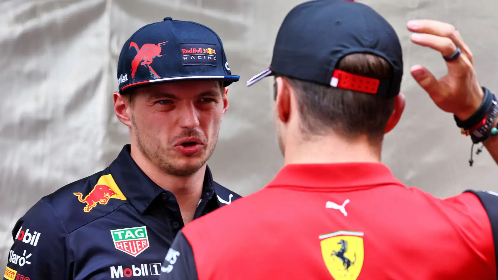 Max Verstappen pulls a face as he speaks with Charles Leclerc. Monaco May 2022