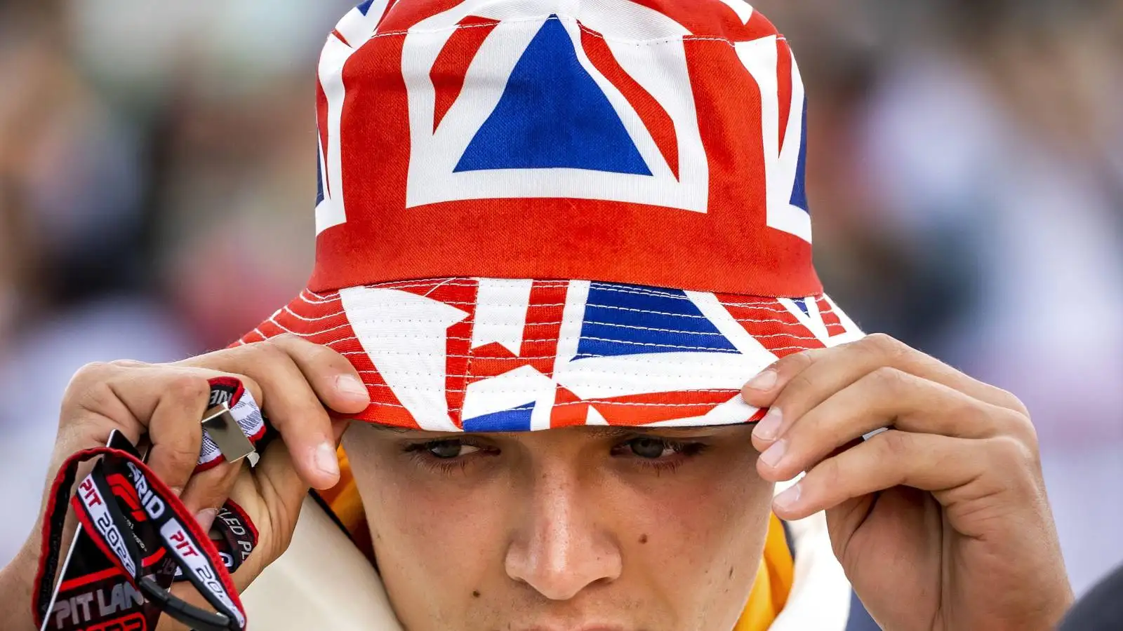 Lando Norris, McLaren, wears a Union Jack hat. F1 England, July 2022.