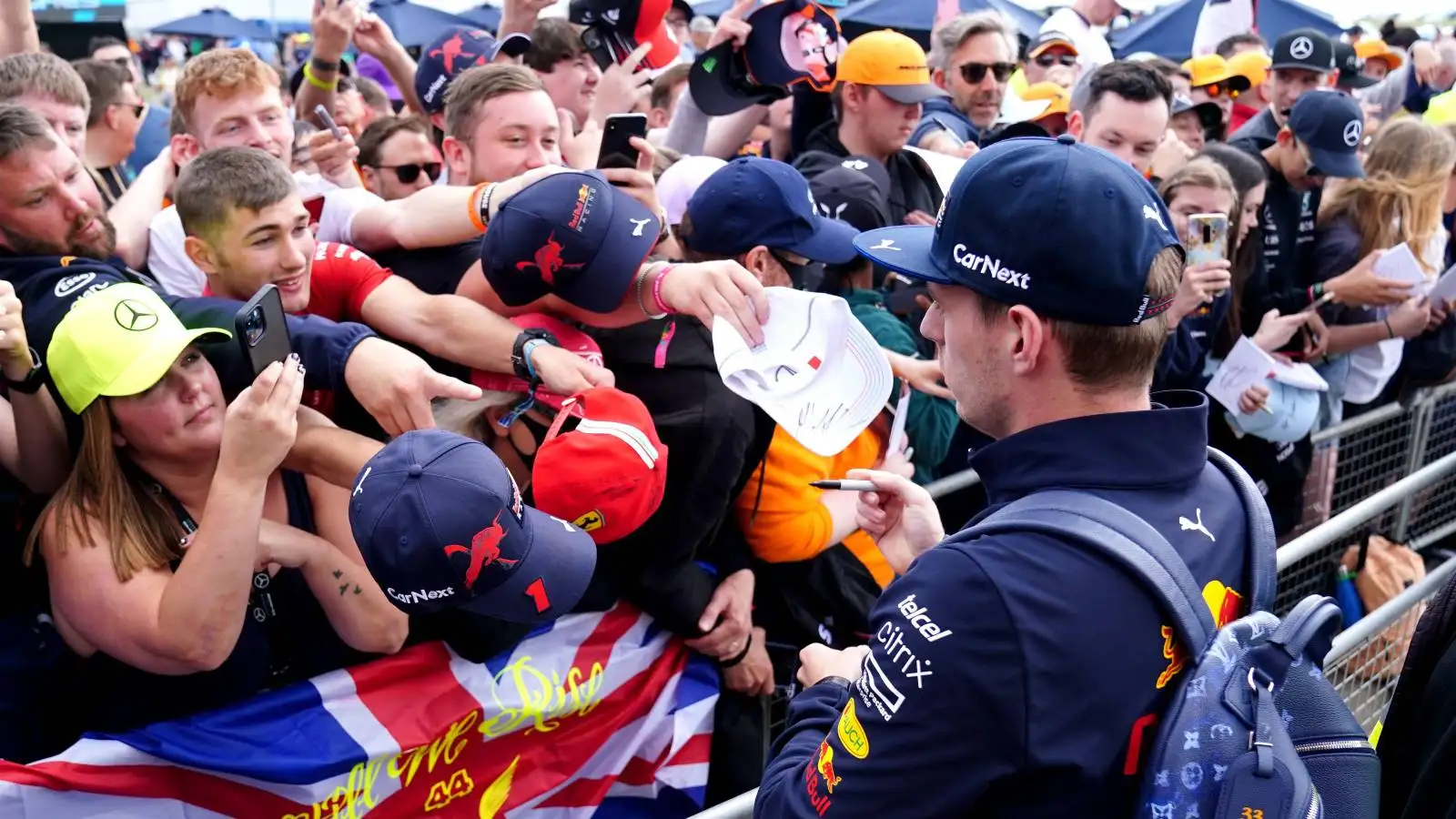 Max Verstappen, Red Bull, signs merchandise for fans. England, July 2022.