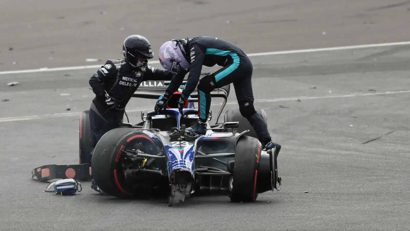 Alex Albon climbs out of his car. Silverstone, July 2022.