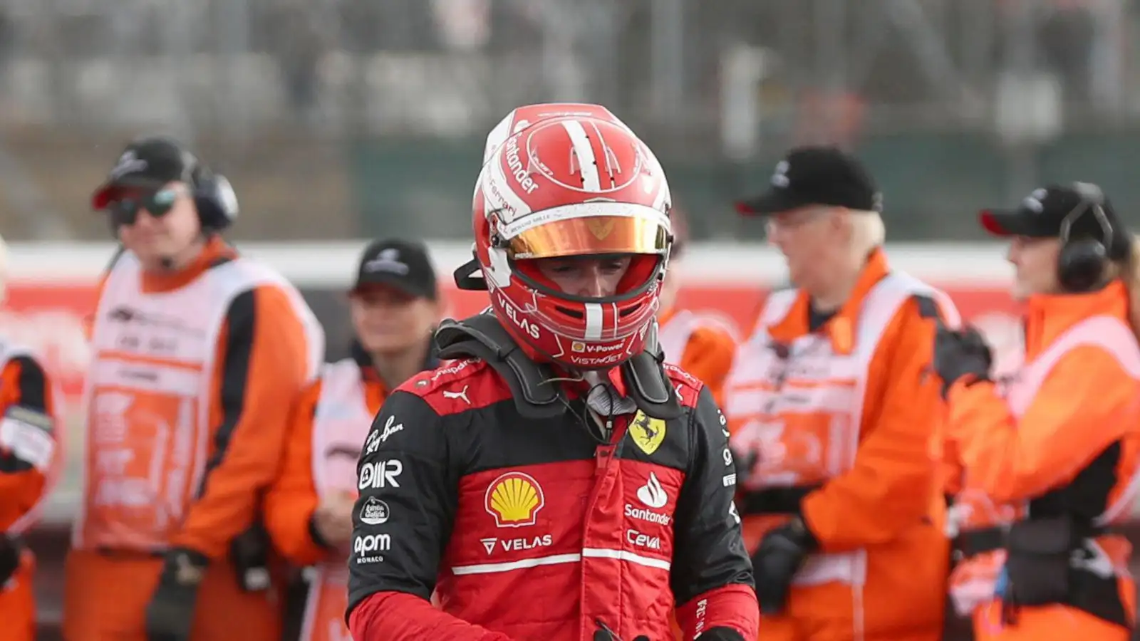 Charles Leclerc after the British Grand Prix, walking past marshals. Silverstone July 2022