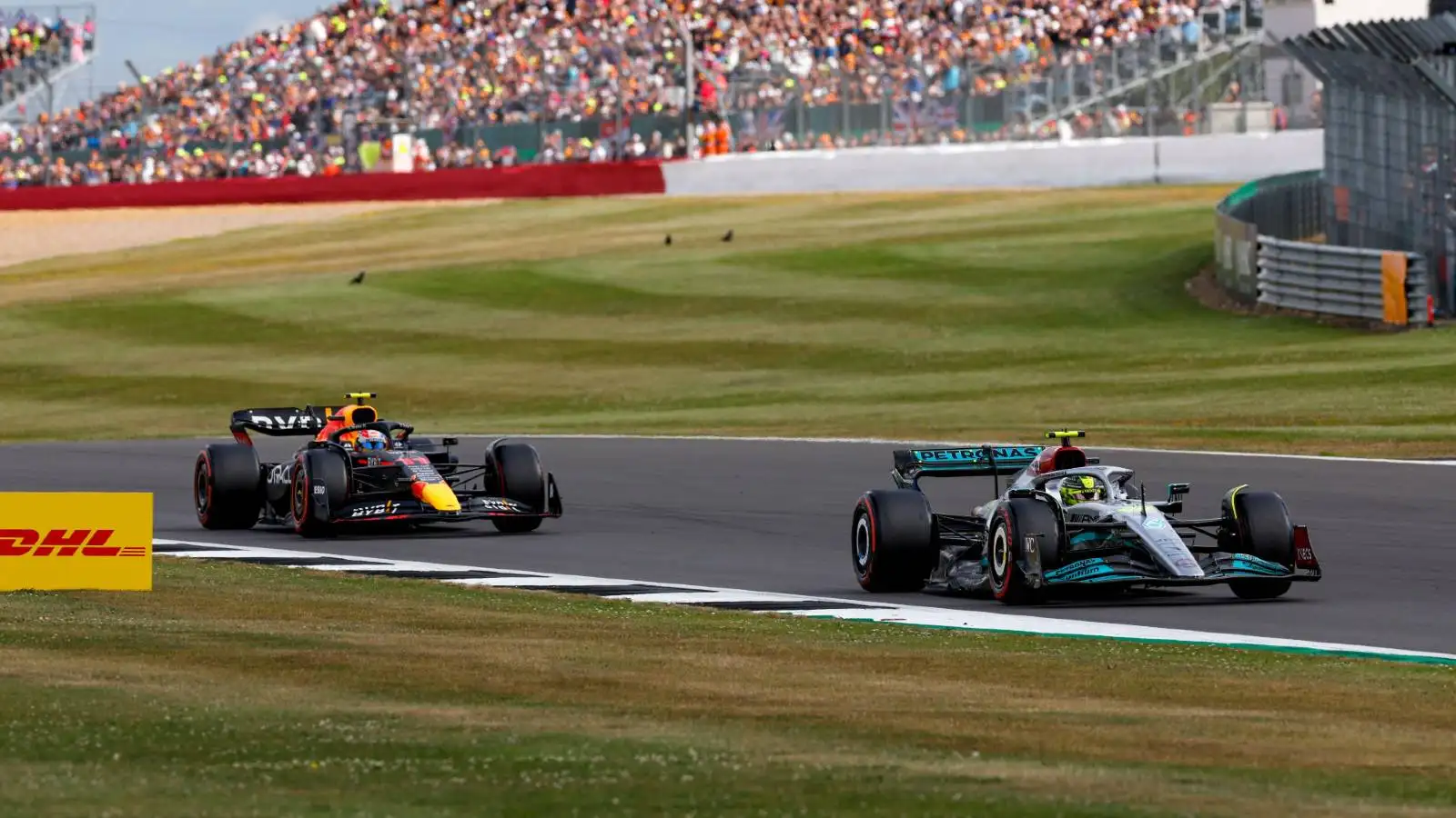 Lewis Hamilton's Mercedes ahead of Sergio Perez's Red Bull. Silverstone July 2022.