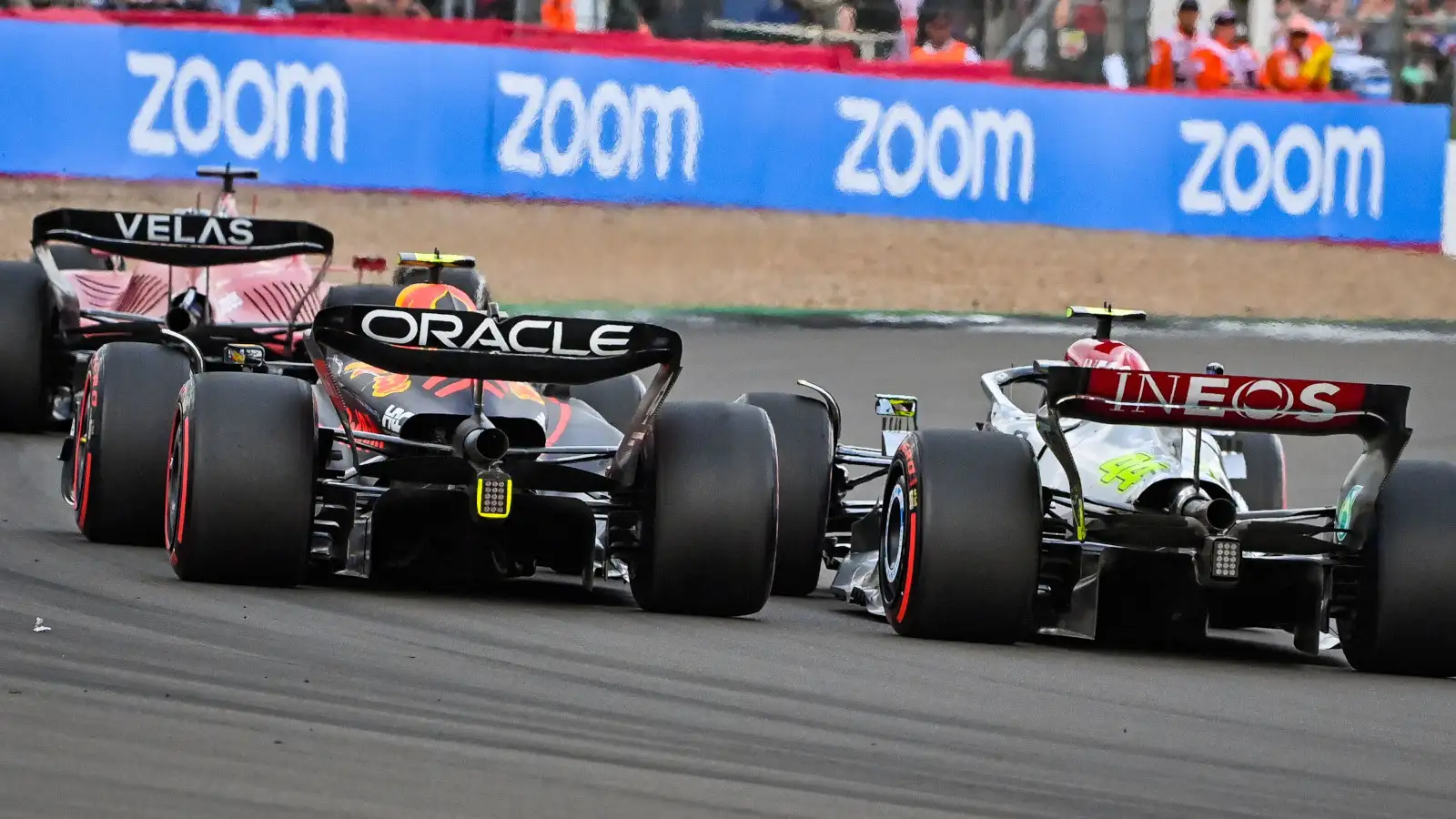 Charles Leclerc trying to defend against Sergio Perez and Lewis Hamilton. Silverstone July 2022