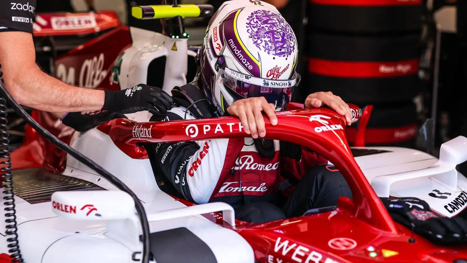 Zhou Guanyu repositioning himself inside the Alfa Romeo cockpit. Austria, July 2022.