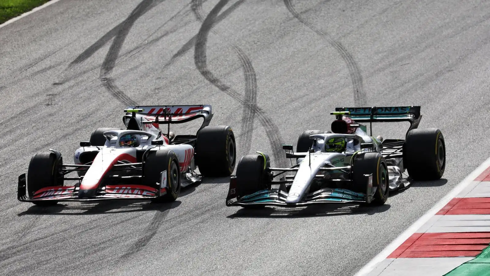 Lewis Hamilton, Mercedes, trying to pass Mick Schumacher, Haas. Austria, July 2022.