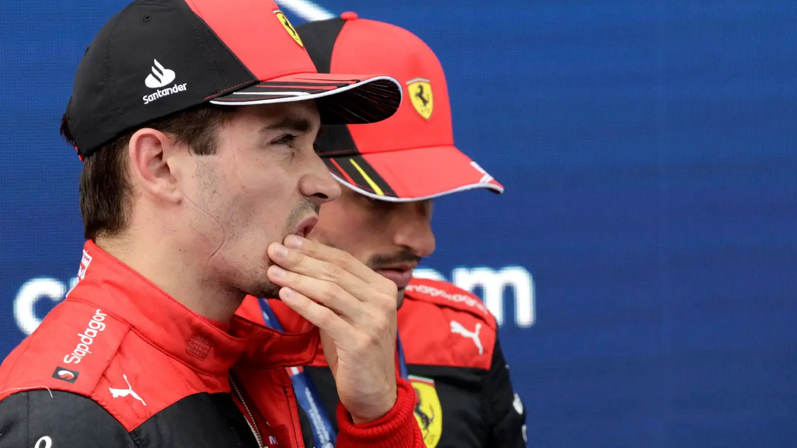 Charles Leclerc standing next to Ferrari team-mate Carlos Sainz. Austria July 2022