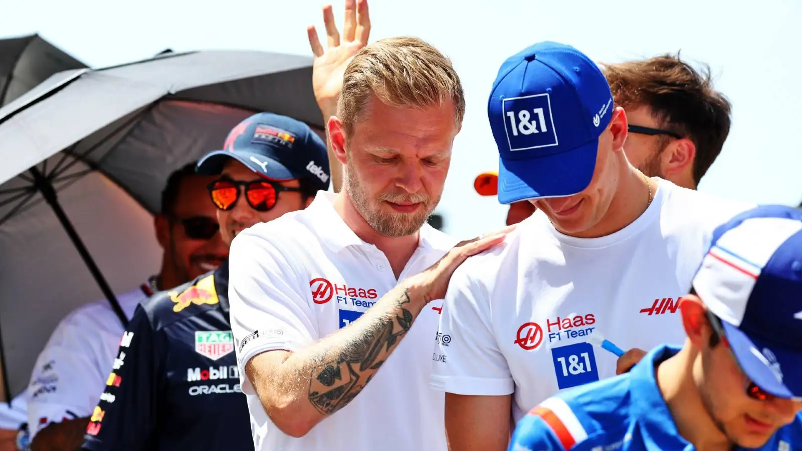 Kevin Magnussen with his hand on Mick Schumacher's shoulder. Barcelona May 2022.